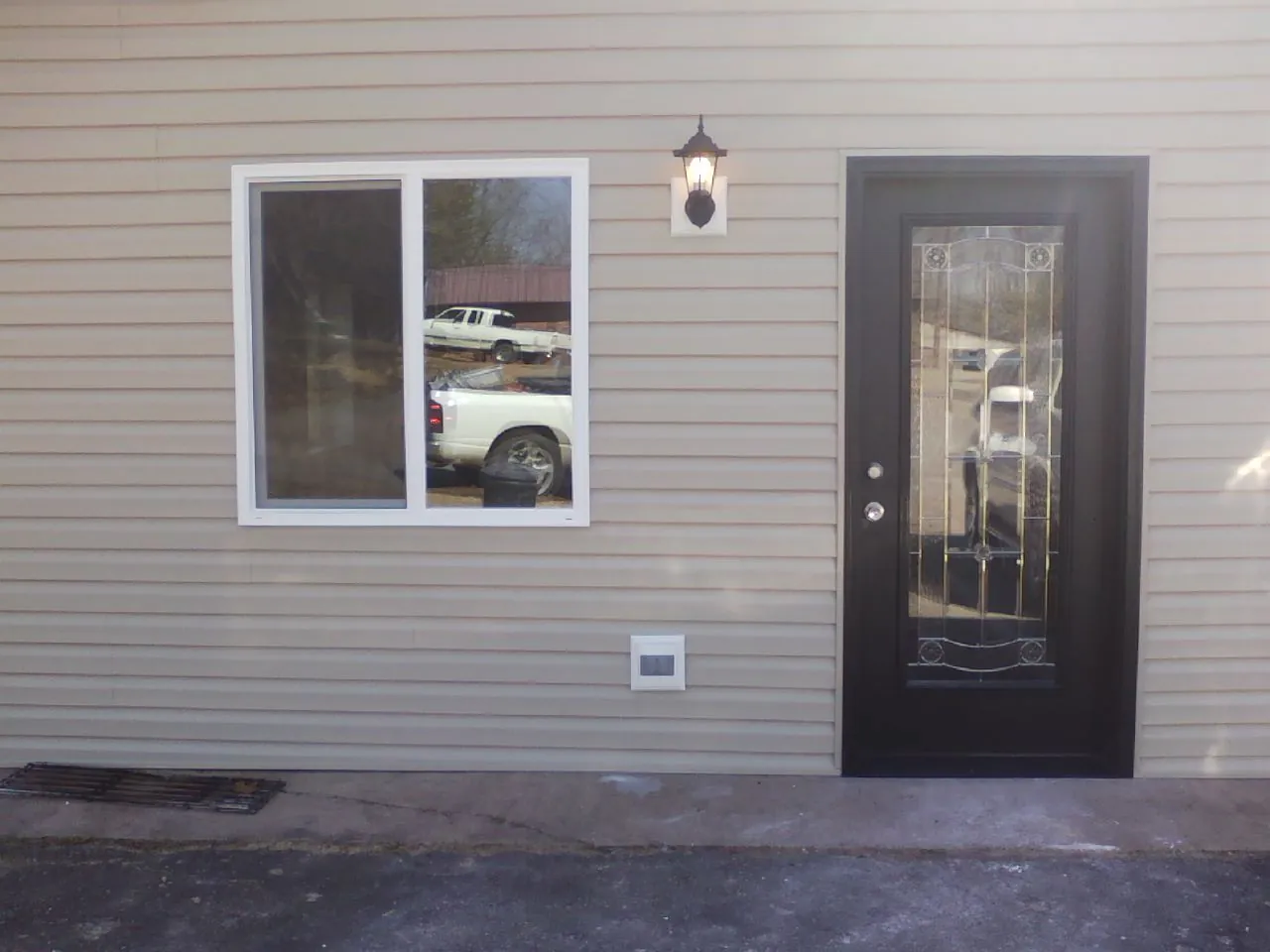New siding, window and entry door on the side of an addition in El Dorado Springs